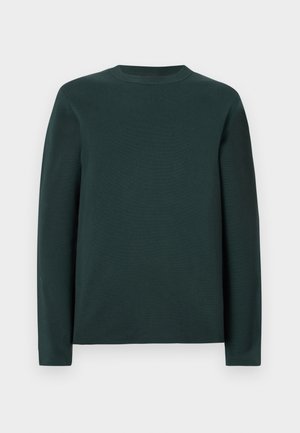 Chemise à manches longues en vert profond, fabriquée en tissu doux. Présente un col rond et une coupe droite, sans motifs ni embellissements visibles.