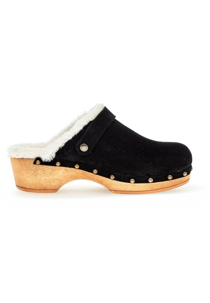 Schwarze Wildlederclogs mit weißem Kunstfellfutter, Holzsohle und Metallnieten entlang der Kante. Klassisches offenes Design mit abgerundetem Zehenbereich.
