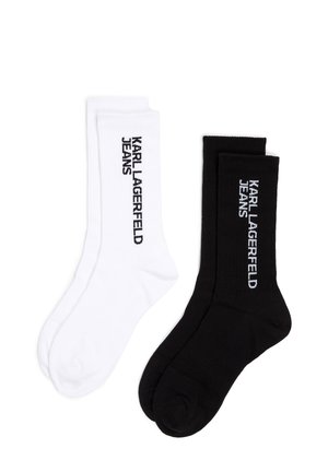 Zwei Paar Socken, eine weiße und eine schwarze, beide mit gerippter Textur und "KARL LAGERFELD JEANS" seitlich bedruckt.