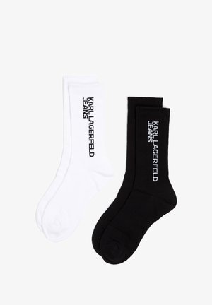 Deux paires de chaussettes, une blanche et une noire, présentent toutes deux une texture côtelée avec "KARL LAGERFELD JEANS" imprimé sur le côté.
