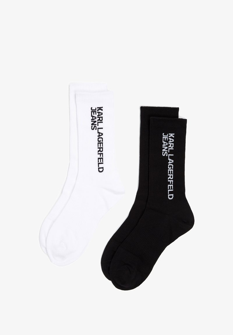 Divas pārus zeķu, vienas baltas un vienas melnas, abas ar ribotu tekstūru un uz sāniem ar izdrukātu "KARL LAGERFELD JEANS".