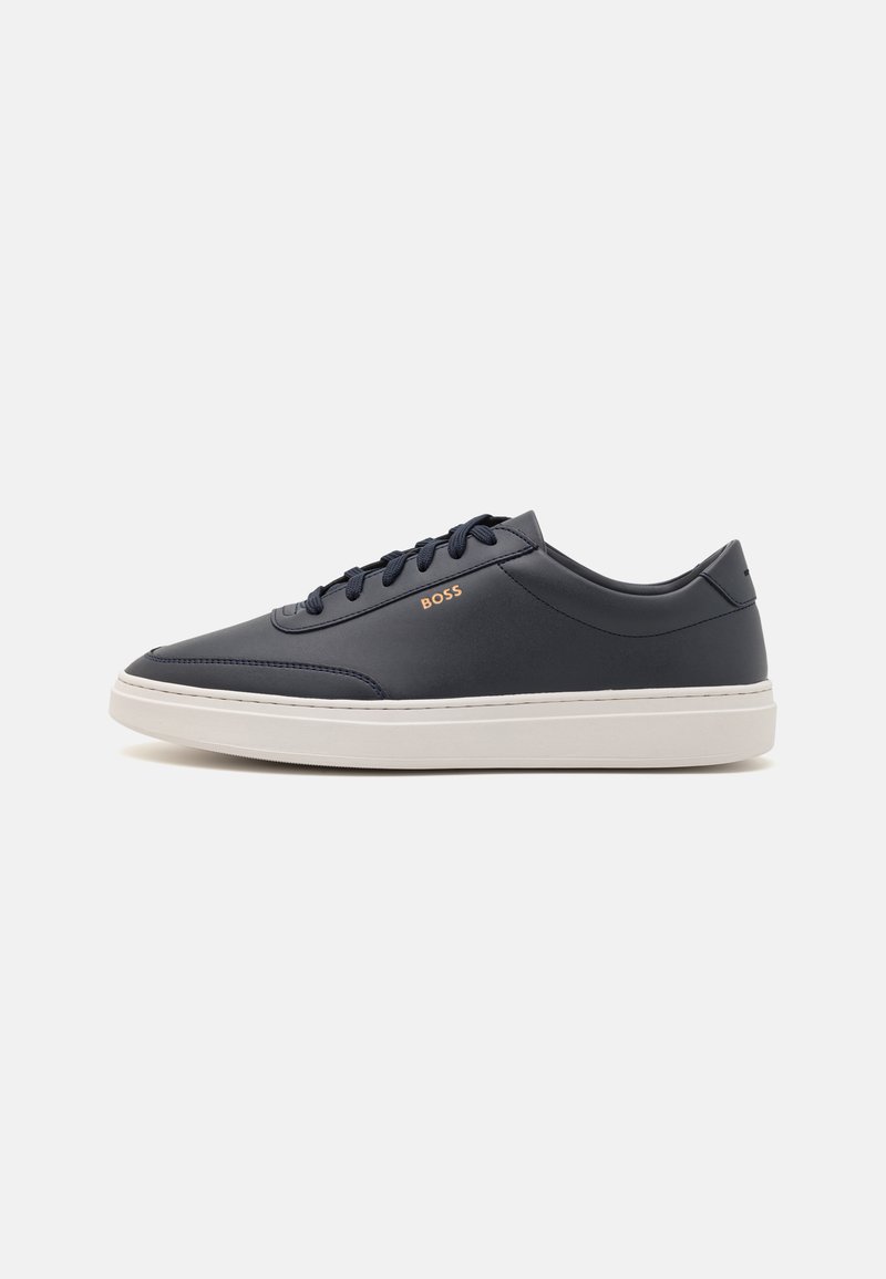 Navy leather sneaker with white rubber sole, flat lace-up design, and subtle branding on the side. Smooth texture with a rounded toe.
