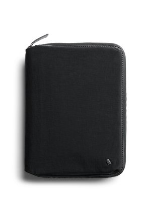 Black fabric zippered pouch with rounded corners and a small silver bird logo in the bottom right corner, photographed on white background.
