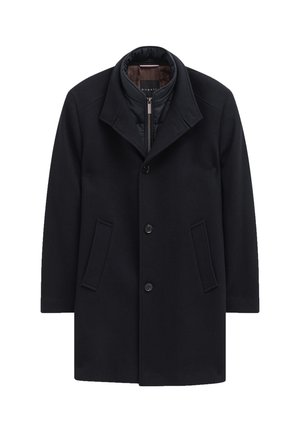 Dunkler Wollmantel mit herausnehmbarer wattierter Fütterung, weitem Kragen, vorne mit Knopfverschluss und zwei Seitentaschen. Strukturierte Oberfläche.