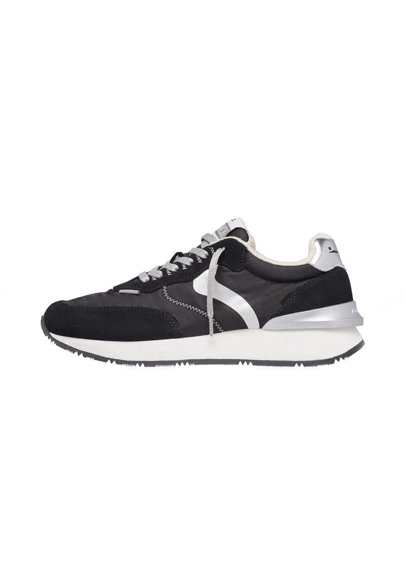 Black athletic shoes with suede and mesh materials, silver accents, and a white midsole. Features a lace-up design and textured outsole.