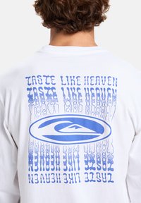 White long-sleeve t-shirt with blue graphic text on the back, featuring a logo and repeating phrase. Text shows a wavy, distorted design.