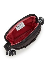 Kipling wallet, black fabric exterior, red interior lining, zip closure, featuring a small monkey keychain, compact design.