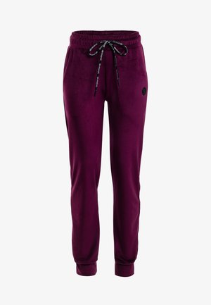 Tumedat lilla tooniga jogger-püksid elastse vöökohtadega, musta värvi pael valge tekstiga, küljetaskud ja mansettidega pahkluud.