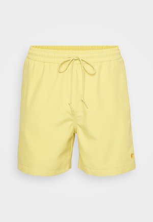 Yellow swim shorts made of lightweight fabric feature an elastic waistband with a drawstring and a small logo detail on the bottom right.
