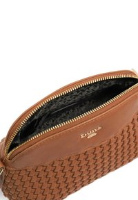 Brown woven leather bag with a zip closure, featuring a gold-tone logo and black patterned lining. Smooth texture and rounded shape.