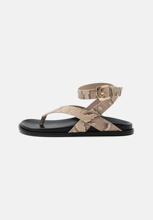 Flat sandal with black sole and beige snakeskin-patterned straps, featuring toe loop and ankle buckle closure.