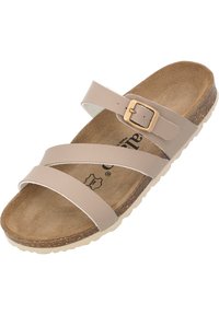Sandal beige con due cinturini larghi e piatti e un accentuato con fibbia. Soletta in sughero con una suola testurizzata e bordo esterno di colore chiaro.