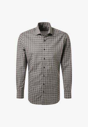 Camicia a maniche lunghe da uomo con motivo geometrico bianco e nero e colletto a punta su sfondo bianco.