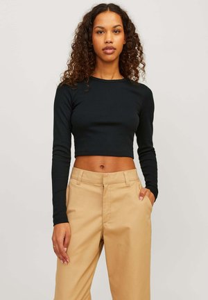 Black ribbed long-sleeve crop top paired with beige high-waisted trousers, featuring side pockets and a smooth texture.