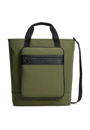 Sac fourre-tout vert olive avec poignées noires, poche avant zippée et bandoulière amovible.