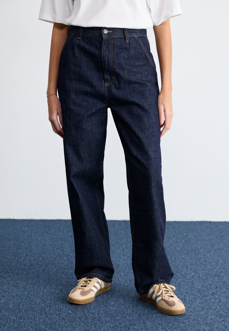 Dark blue, high-waisted denim jeans with a straight leg design. Detailed with yellow stitching and a front button closure.