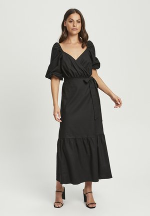 Black midi wrap dress with puff sleeves, a fitted waist, and a tiered skirt. Made of smooth fabric with tie detailing at the waist.