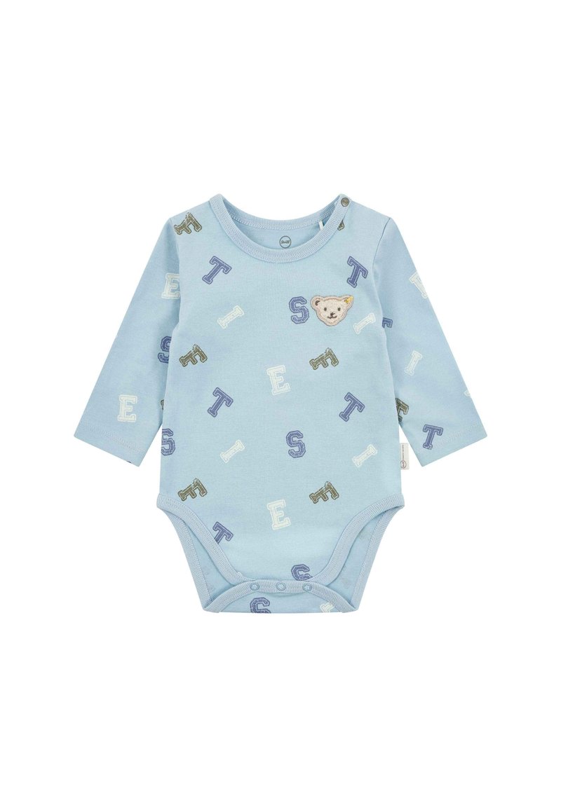 Světle modrý overal s dlouhým rukávem, který má motiv medvěda a rozptýlené barevné písmena. Měkká bavlněná látka s patentkami na spodní části.
