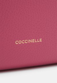Coccinelle MALORY - Cross body bag - rosewood