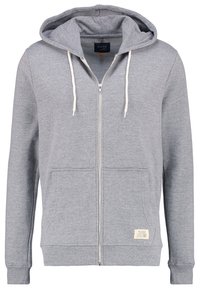 Sudadera con cremallera de color gris claro, con bolsillos frontales, cordones blancos, puños y dobladillo acanalados, y un pequeño parche de marca cerca del dobladillo inferior.