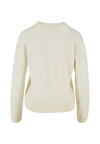 Pull en tricot couleur crème avec des manches longues, ourlet et poignets côtelés, et une coupe décontractée. Texture douce avec un minimum de décorations.
