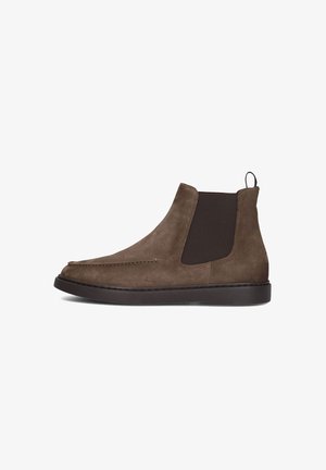 Brown suede Chelsea boots with elastic side panels and a pull tab. Features a round toe and a flat rubber sole. Simple stitching detail.