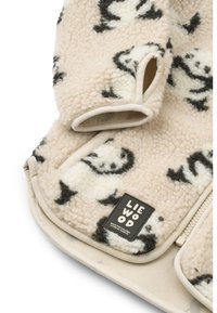 Κουβέρτα από φλις με κρεμ φόντο και μαύρο σχέδιο πάντα. Διαθέτει στρογγυλεμένες γωνίες και ραμμένη ετικέτα με το όνομα της μάρκας. Μαλακή υφή.