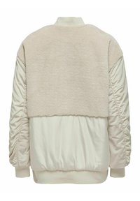 Giacca bomber beige con un pannello posteriore peloso, maniche imbottite e polsini a coste. Tessuto liscio e dettagli laterali arricciati.