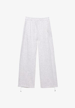 Helle graue weit geschnittene Hose aus weicher, strukturiertem Stoff. Mit elastischem Bund und Kordelzug am Saum. Zwei Seitentaschen.