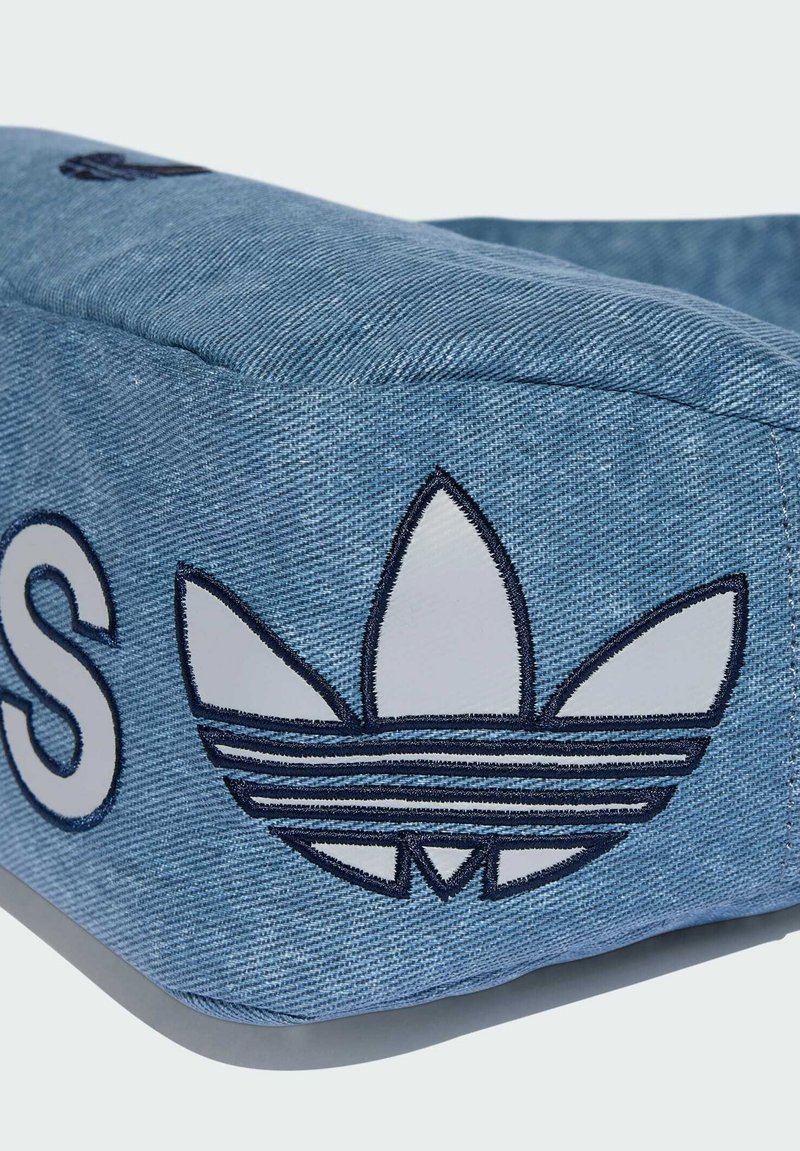 Cappello di jeans dalla forma arrotondata, con logo ricamato bianco e cuciture blu. Texture liscia con motivi a contrasto sul lato.