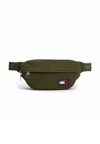 Sac banane en velours côtelé vert olive avec poche avant zippée et patch logo Tommy Jeans, sangle réglable avec texte de la marque.