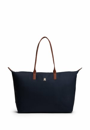Borsa tote blu navy in nylon con manici in pelle marrone, con logo dorato sulla parte anteriore e chiusura superiore con zip.