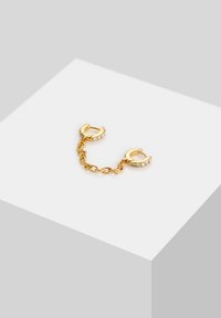 Kuldne ahelikukinnitus, millel on kaks ümmargust klambrit, millel on selged rhinestone aktsendid. Sleek disain ja sile tekstuur.