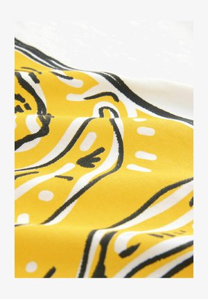 Yellow fabric with black and white abstract patterns. The material has a smooth texture, displaying curved lines and dots in a playful design.