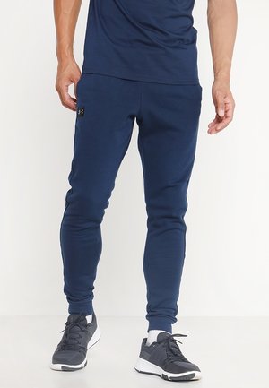 Marineblaue Sport-Jogginghosen aus weichem Stoff, mit eng anliegender Passform, zulaufenden Beinen und einem kleinen Logoakzent an der linken Hüfte.
