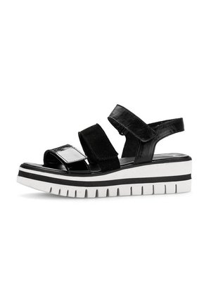 Zwarte platform sandalen met twee verstelbare banden. Glanzende en matte afwerkingen, voorzien van een chunky witte zool met zwarte strepen en een getextureerde loopzool.