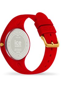 Orologio da polso in silicone rosso con quadrante rotondo trasparente, accenti dorati e cinturino testurizzato. Impermeabile fino a 10 ATM. Numero di modello 022 459.