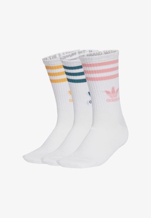 Três pares de meias brancas com riscas coloridas: amarelo, teal e rosa. Cada par apresenta uma marcação no tornozelo e uma textura canelada na parte superior.