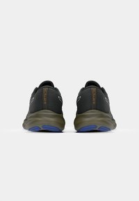 Black athletic shoes with a mesh upper, rounded heel, and grey-brown sole featuring blue accents. Reflective detailing along the sides.