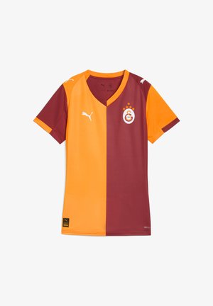 Maglia da calcio marrone e arancione con scollo a V, maniche corte e logo sul petto. Realizzata in materiale leggero con un design a doppio strato.