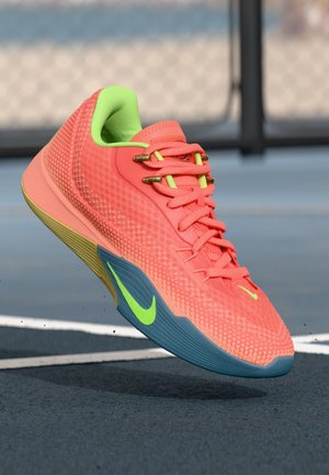 Nike athletic shoe with a breathable coral mesh upper, neon green accents, gold eyelets, and a blue rubber sole, designed for performance.