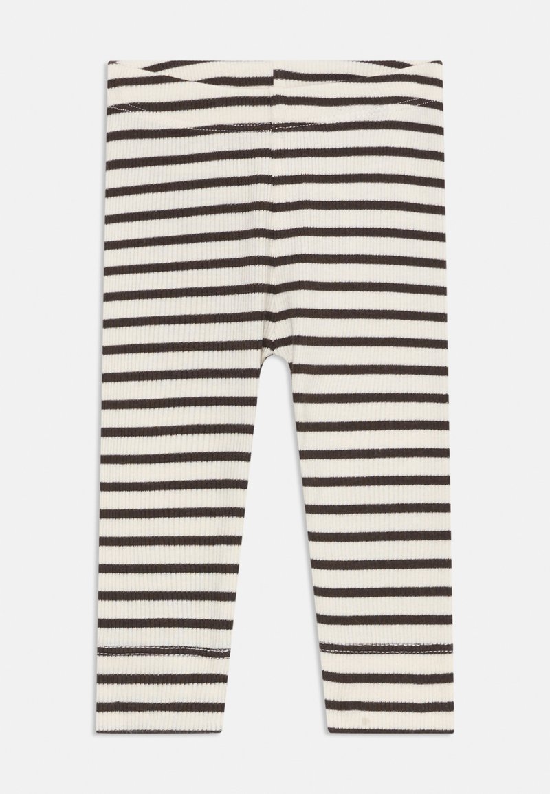 Leggings com nervuras em branco com riscas horizontais castanhas escuras; design ajustado com cintura elástica e bainhas cosidas.