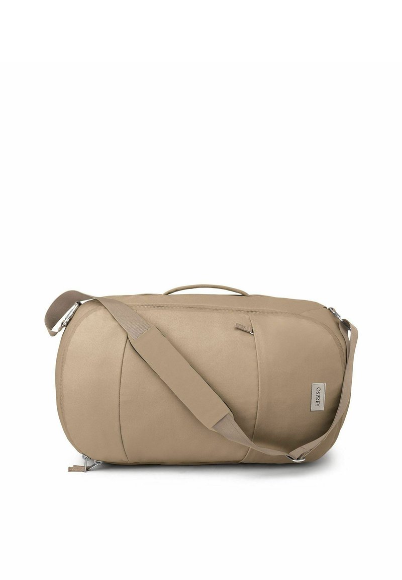 Beige Duffel-Tasche aus weichem Material, mit geschwungener Form, Schultergurt, Tragegriff und einer Fronttasche mit Reißverschluss sowie Markenlogo.