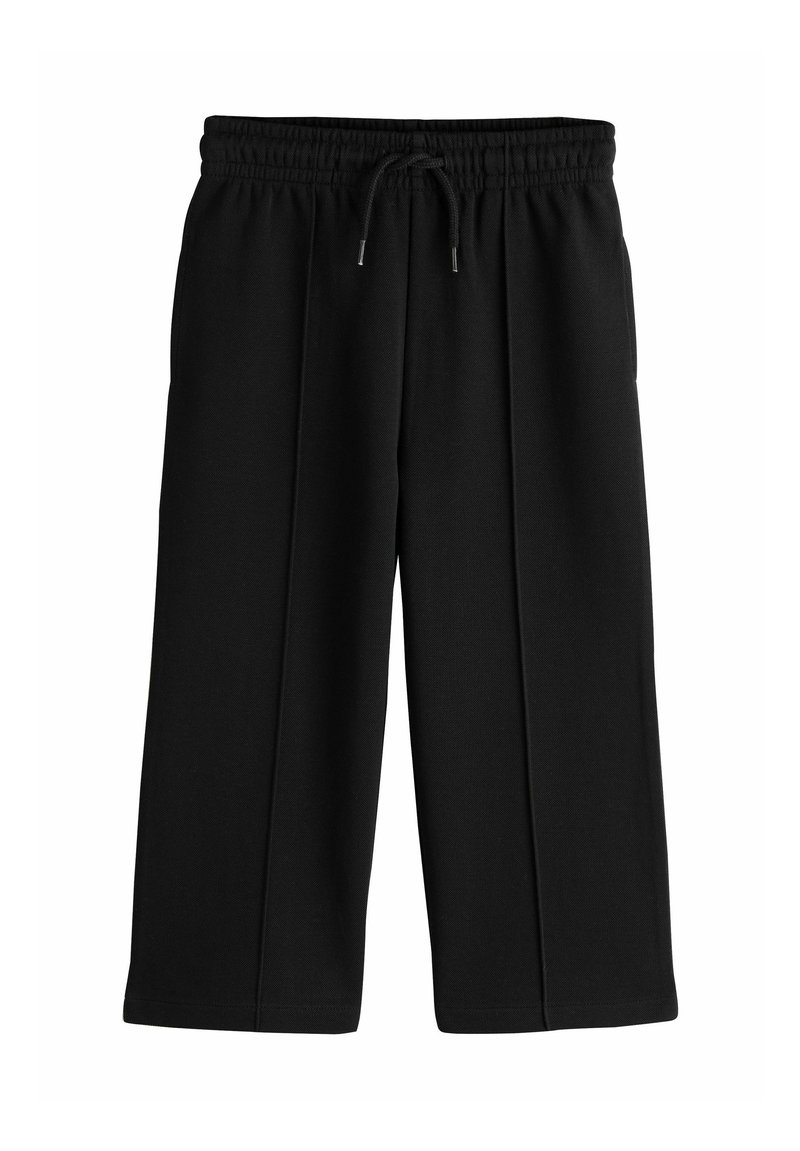 Pantalones negros de pierna ancha hechos de una tela suave y texturizada. Cuentan con una cintura elástica con cordón y pliegues frontales sutiles.