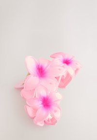 Pink hair clip with three flower designs, featuring a glossy finish and gradient petals transitioning from soft pink to deeper pink at the center.
