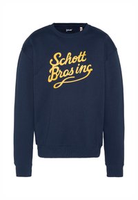 Felpa blu navy in cotone con maniche lunghe e polsini a coste, caratterizzata da una grafica gialla con la scritta "Schott Bros inc" sul davanti.