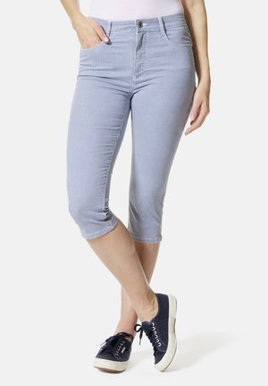 Blue and white striped cropped pants with a fitted design, front pockets, and cuffed hems, paired with navy sneakers.