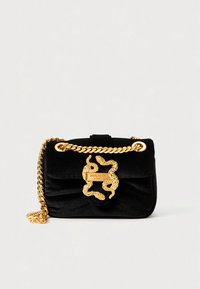 Black velvet handbag with a gold snake-shaped clasp and chain strap. Features a fold-over flap and a smooth, soft texture.
