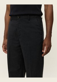 Dark gray trousers with a textured fabric, featuring a button closure, side pockets, and a straight-leg design.