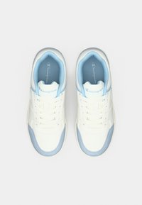 Λευκά και ανοιχτό μπλε αθλητικά παπούτσια Champion, σε θέα από πάνω, με κορδόνια και μαλακούς γιακάδες, σε απλό φόντο.